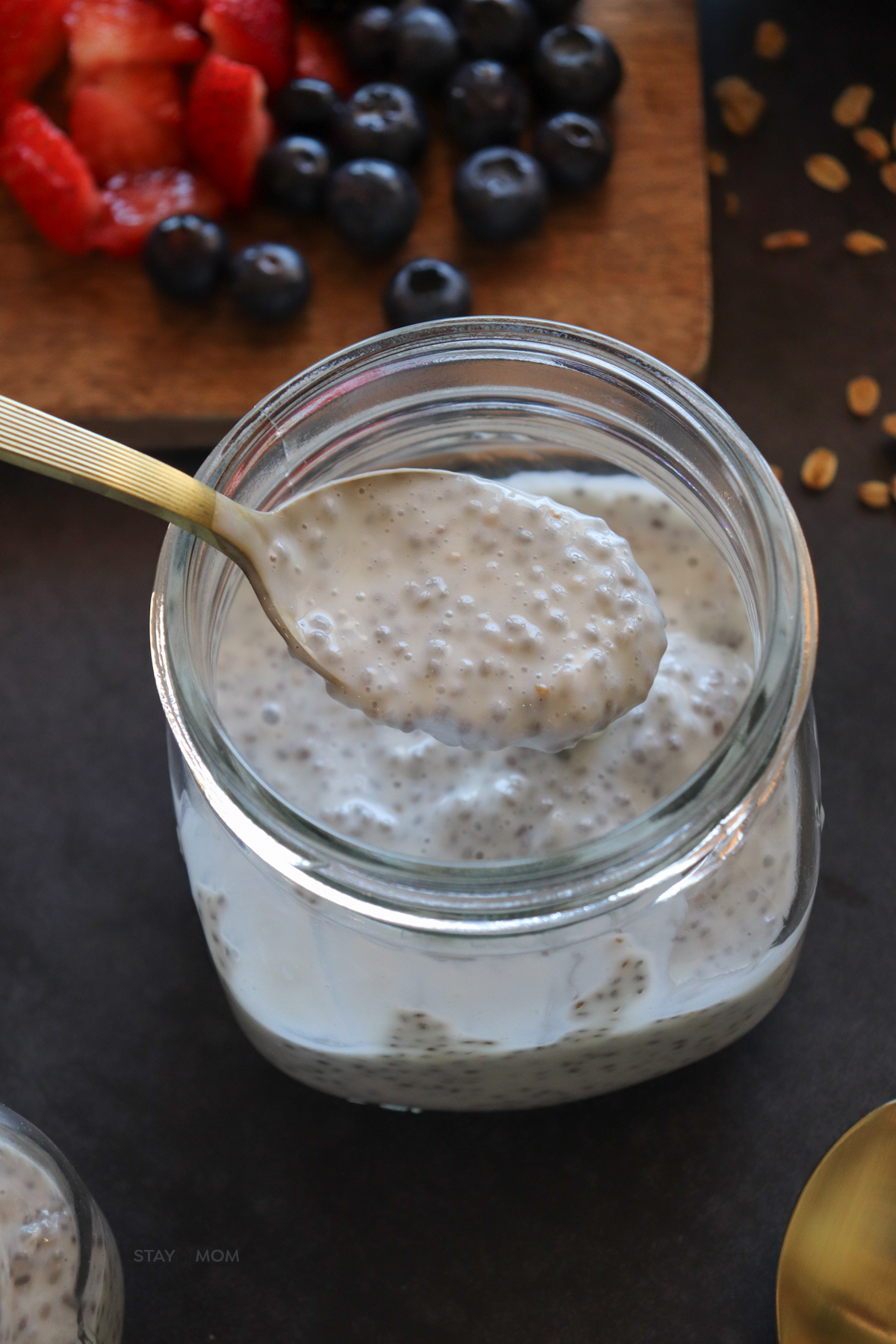 Vanilla chia pudding showing a jar of pudding with a spoonful above to show texture.