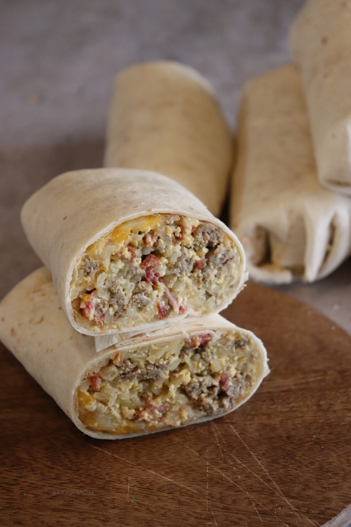 Mach Breakfast Burritos showing finished burrito cut in half with the two halves stacked on top of each other to show filling.