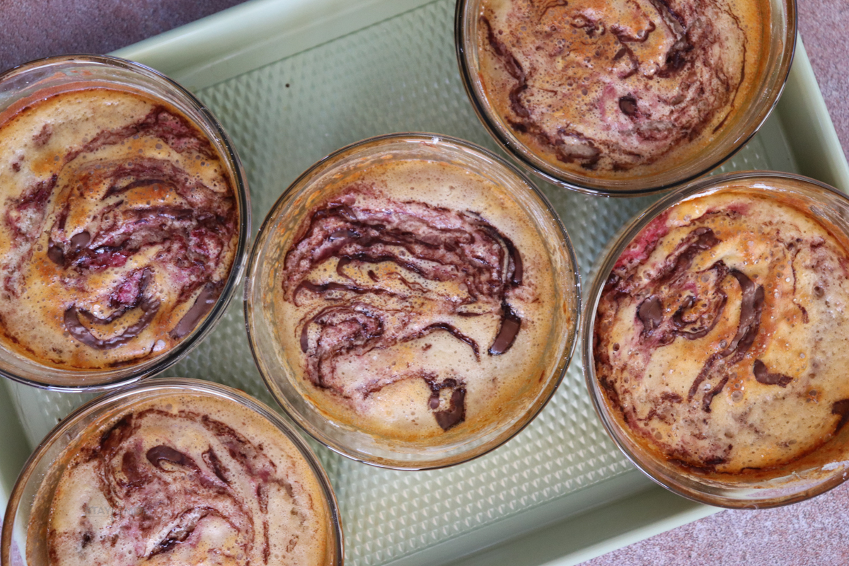 Real Strawberry Nutella Protein Pancake Bowls showing finished recipe with pancake bowls swirled with strawberries and Nutella.