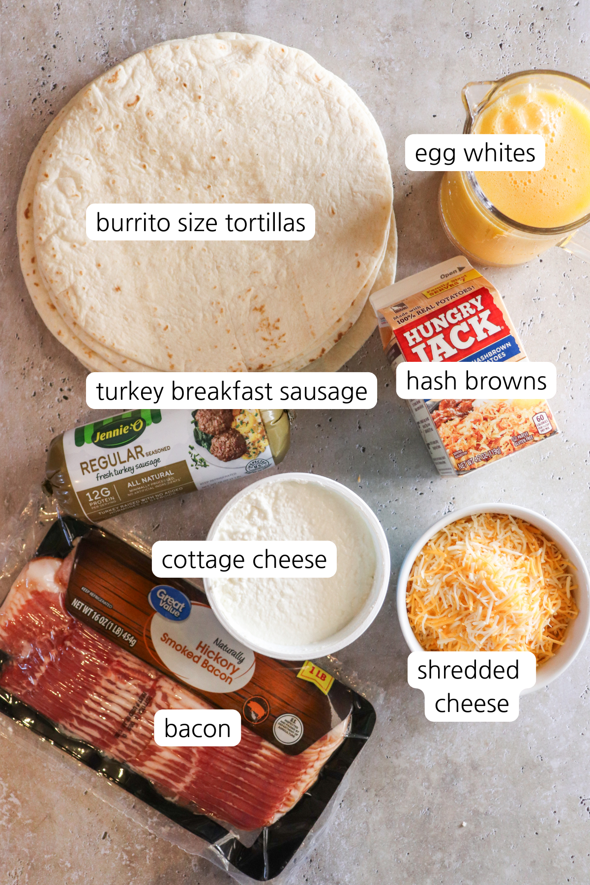 Macho Breakfast Burrito showing labeled ingredients: burrito sized tortillas, egg whites, hash browns, turkey breakfast sausage, bacon, cottage cheese, and shredded cheese.