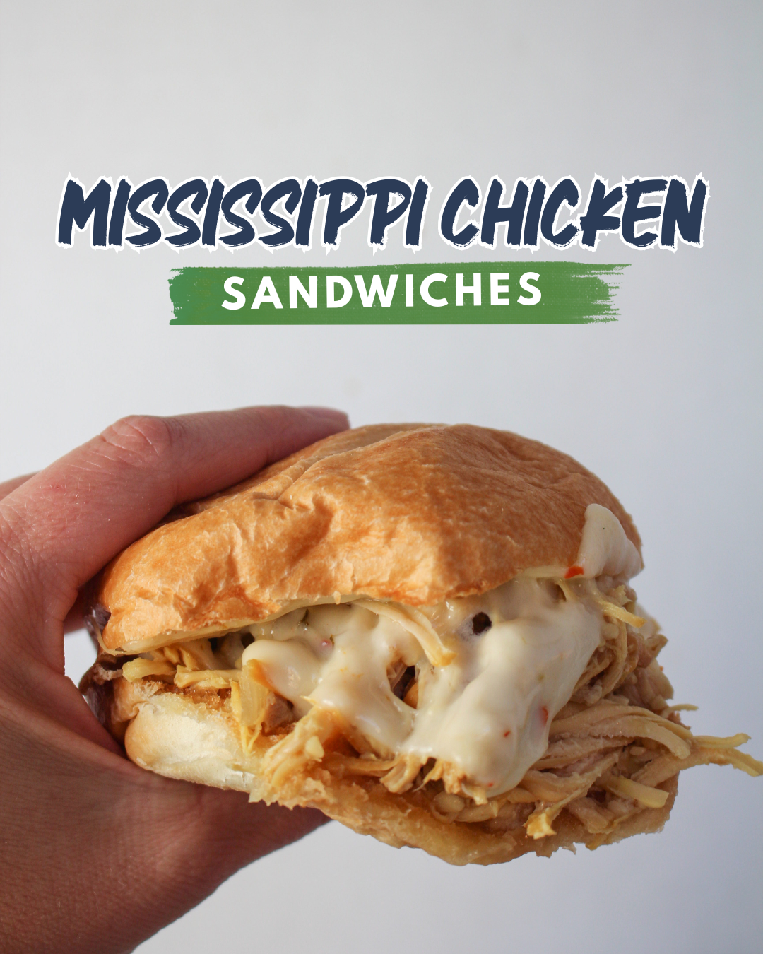 Mississippi Chicken on a toasted bun with melted cheese.