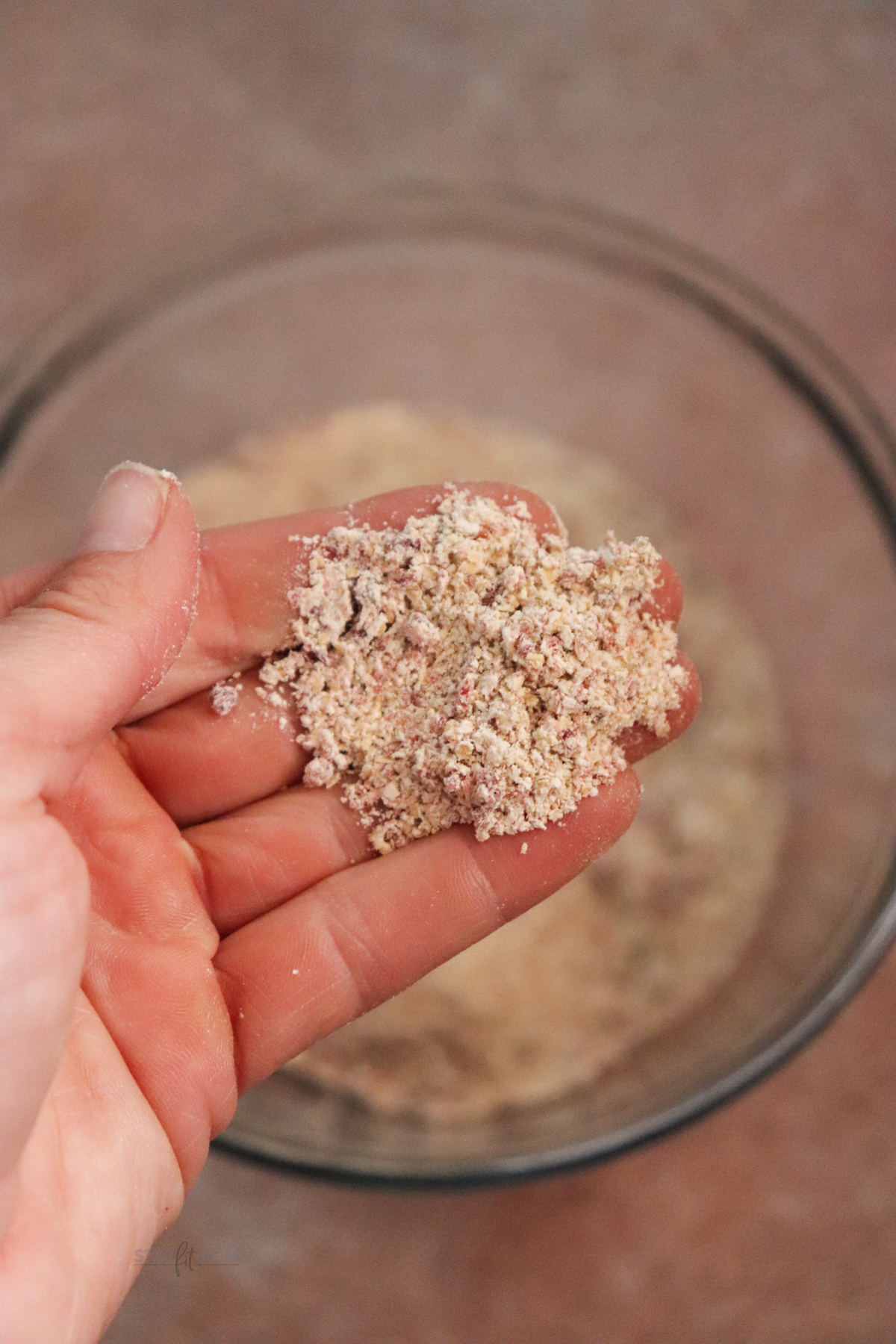 Krista showing a close-up of blended oats and raisins to show texture.