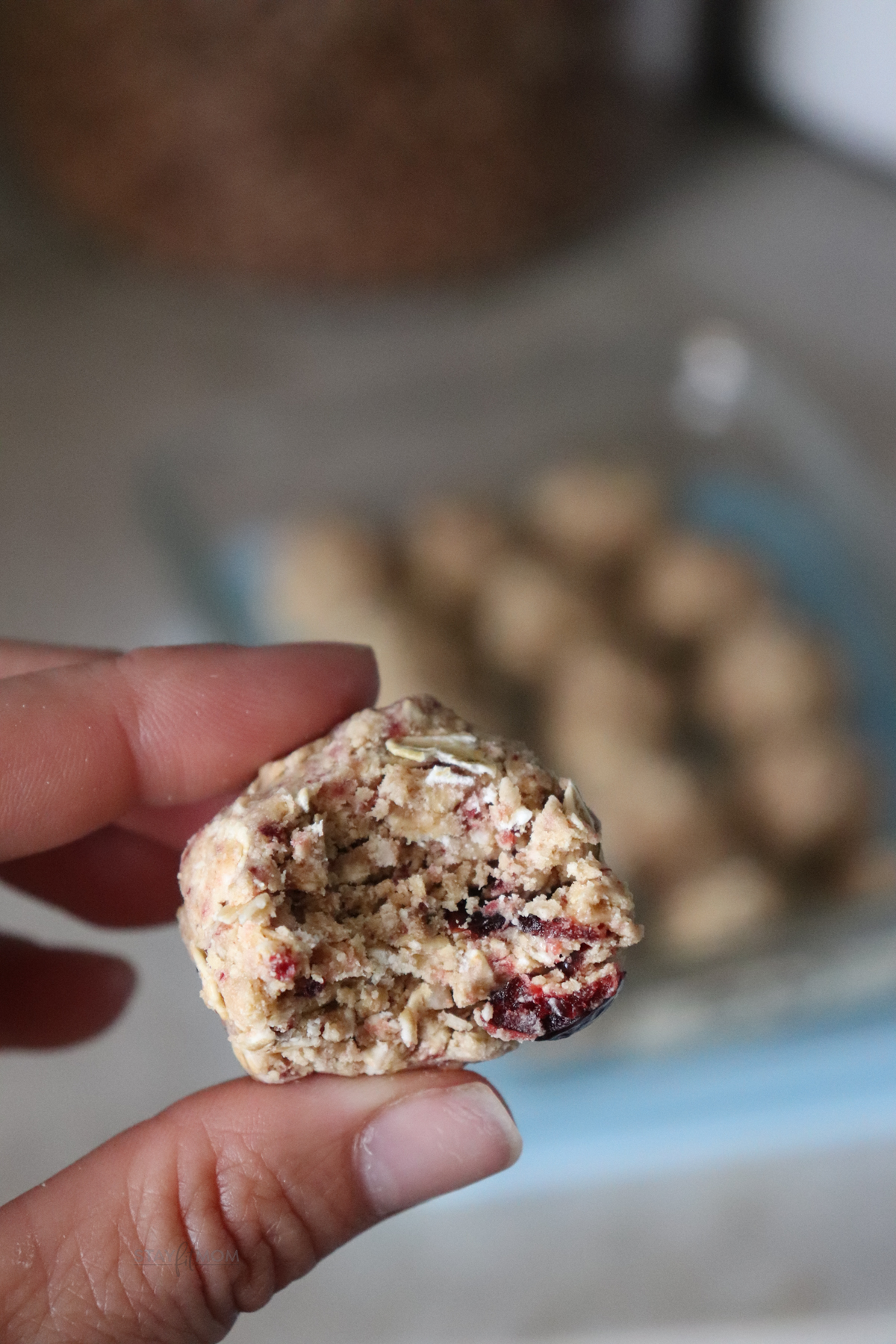 PB&J protein bites showing a close up of a protein ball with a bite taken out of it.