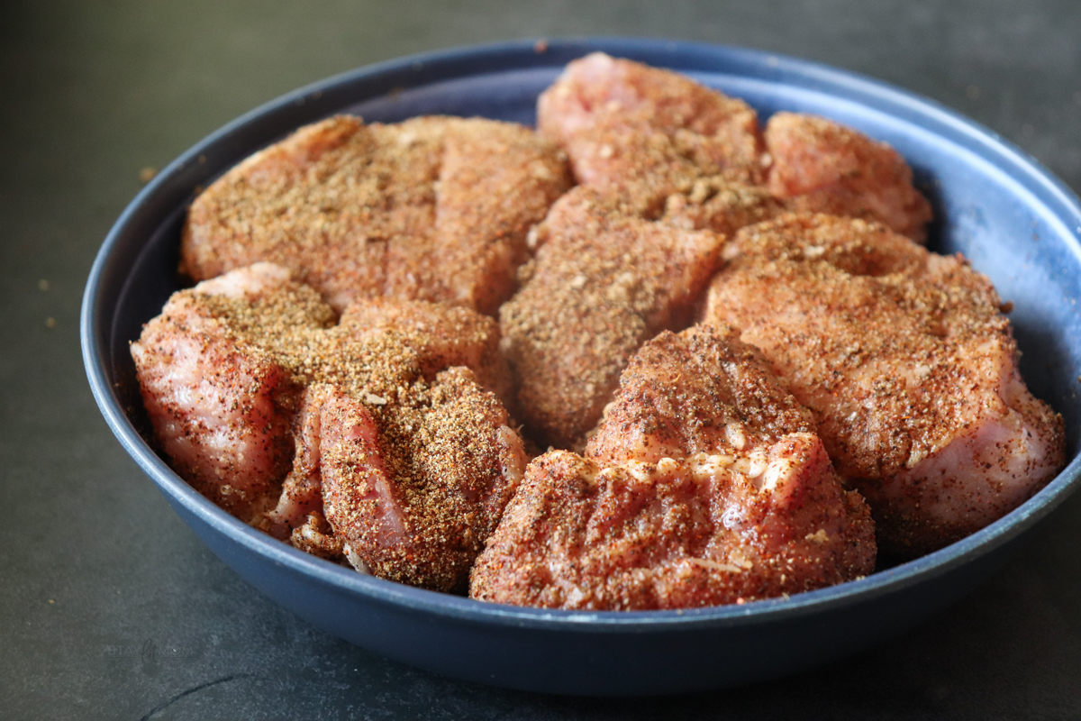 Pork loin cut into small chunks and seasoned, ready to be seared.