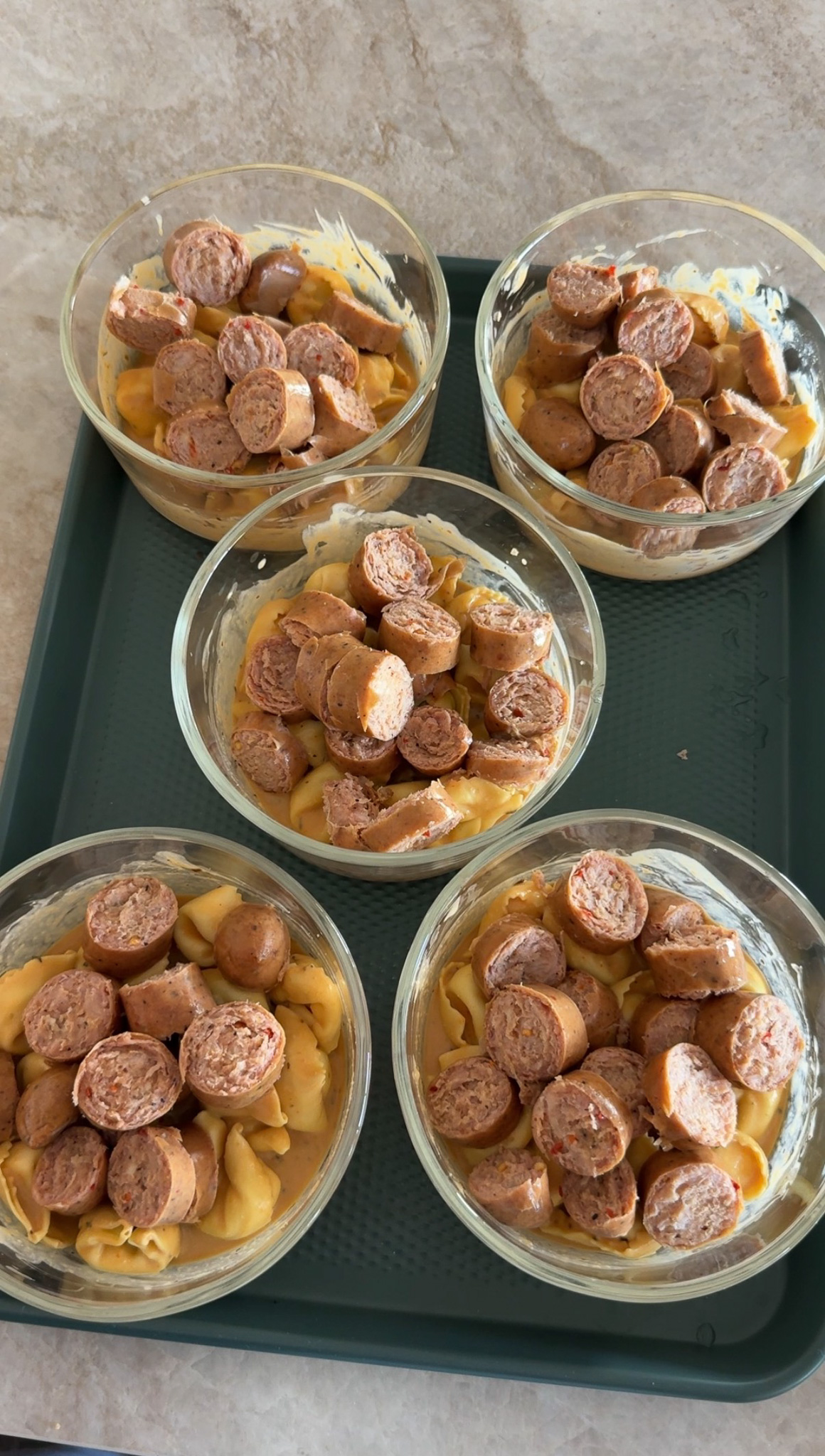 Pumpkin Tortellini Bowls showing bowls with pumpkin and tortellini mixture in the bottom and topped with slices of chicken sausage.
