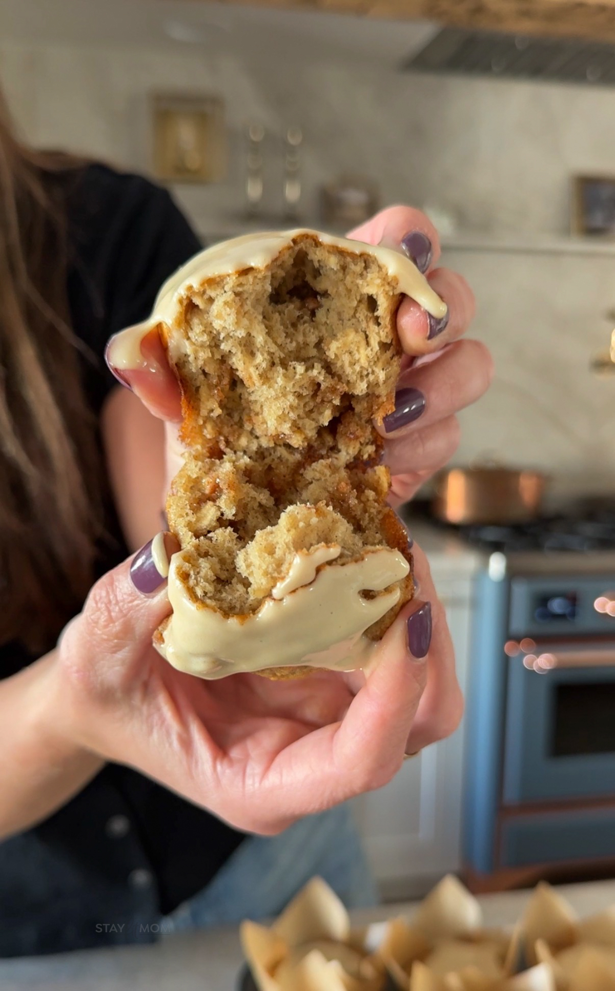 Maple Cinnamon Muffins showing Krist breaking a muffin half to show the soft, fluffy texture.