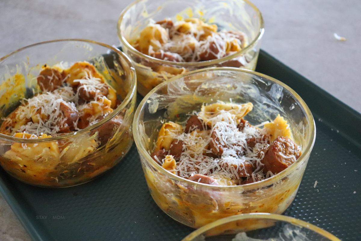 3 meal prep bowls showing completed recipe topped with Parmesan cheese.