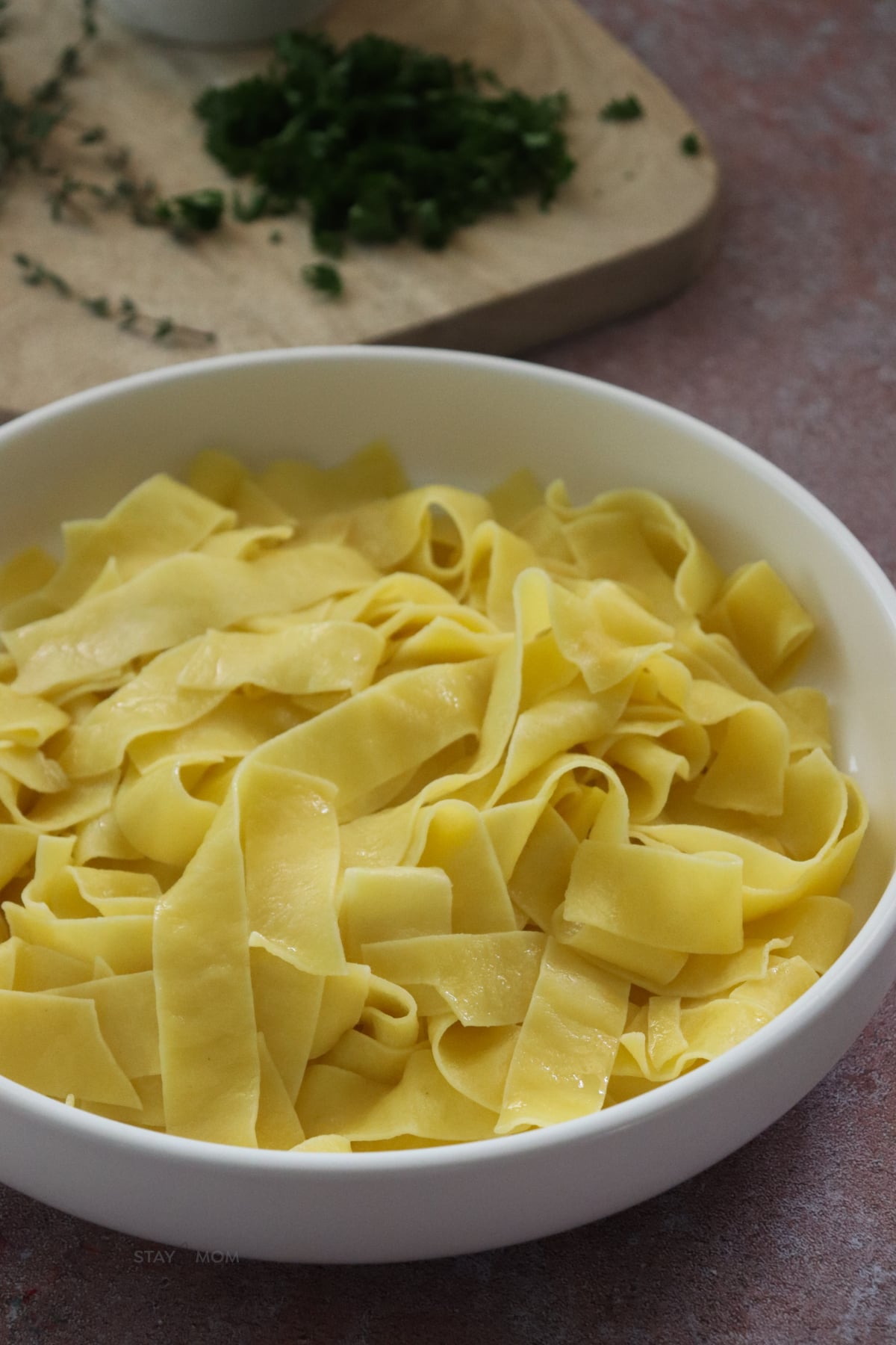 A white bowl filled with cooked pasta.