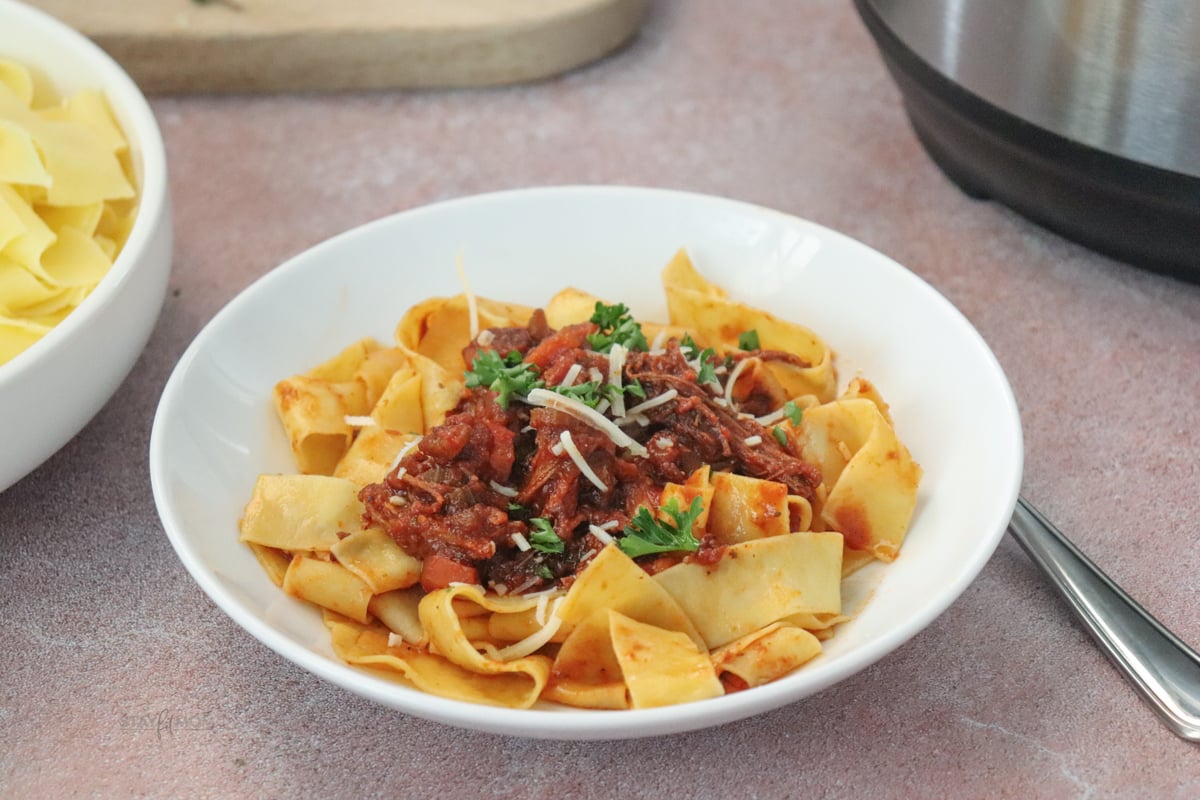 Beef Ragu showing completed recipe served over pasta.