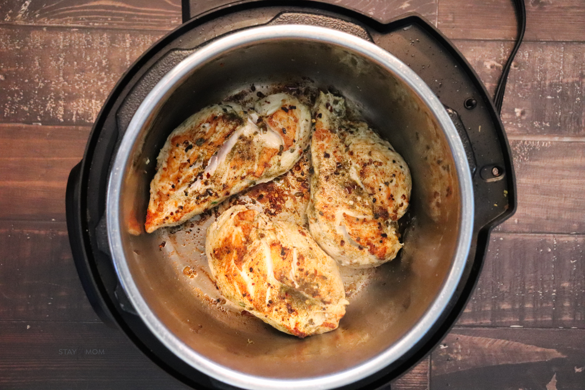 Marry Me Chicken showing an Instant Pot with browned chicken breast.