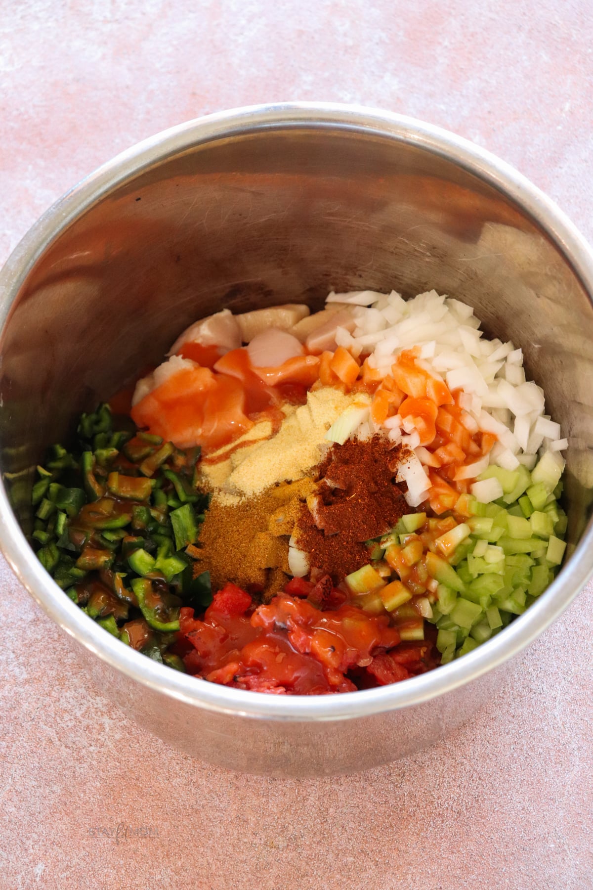 Instant Pot liner filled with chicken veggies, and spices.