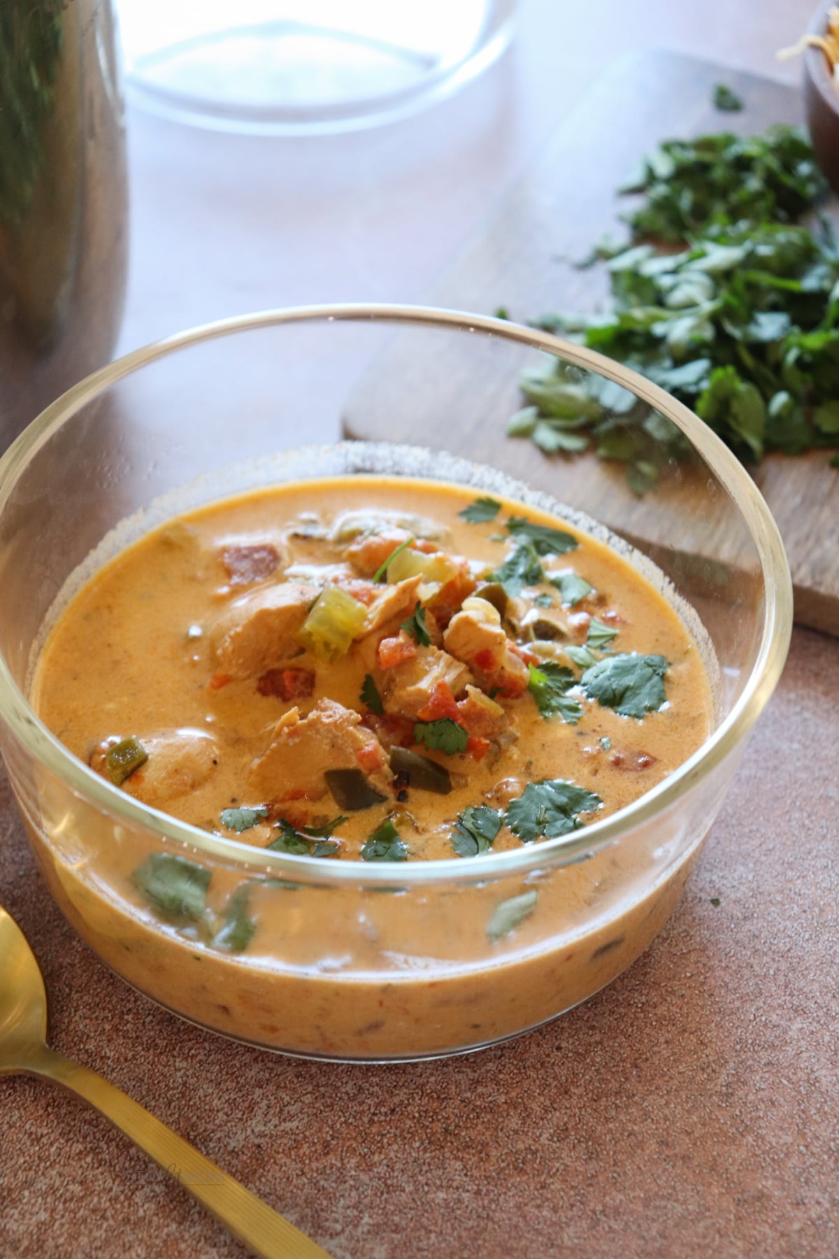 Buffalo Chicken Chili showing a glass bowl with a serving of soup.